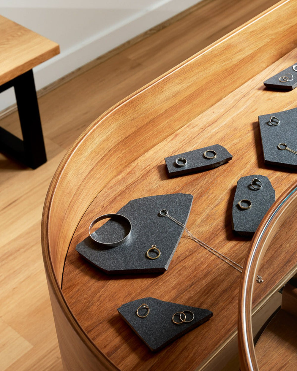 Rings laid out on the timber display counter at the WILLIAM ÉDOUARD showroom