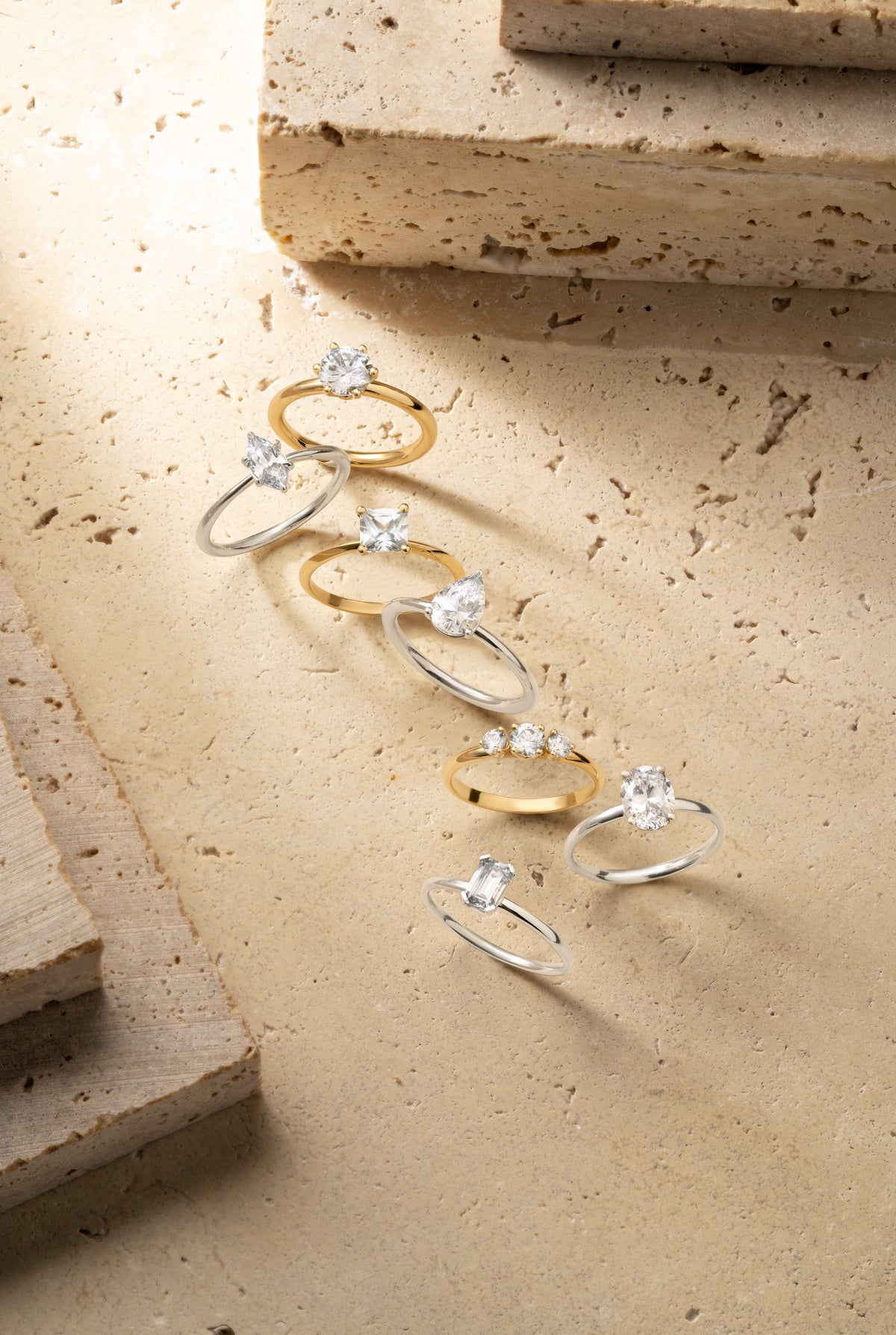 Selection of diamond engagement rings in yellow and white gold featuring round, oval, pear and emerald cuts by William Edouard