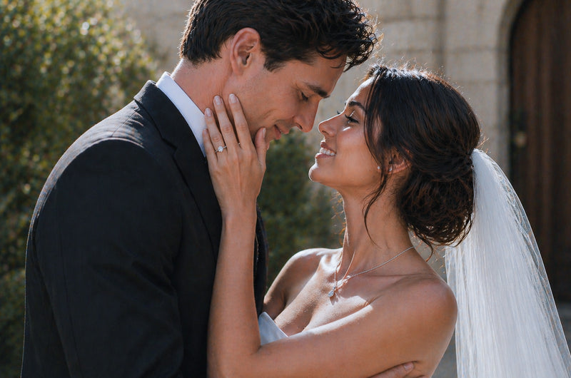 Bride wearing a diamond solitaire engagement ring in white gold during an intimate wedding moment by William Edouard