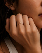 Minimalist yellow gold chevron stacking ring on hand by William Edouard