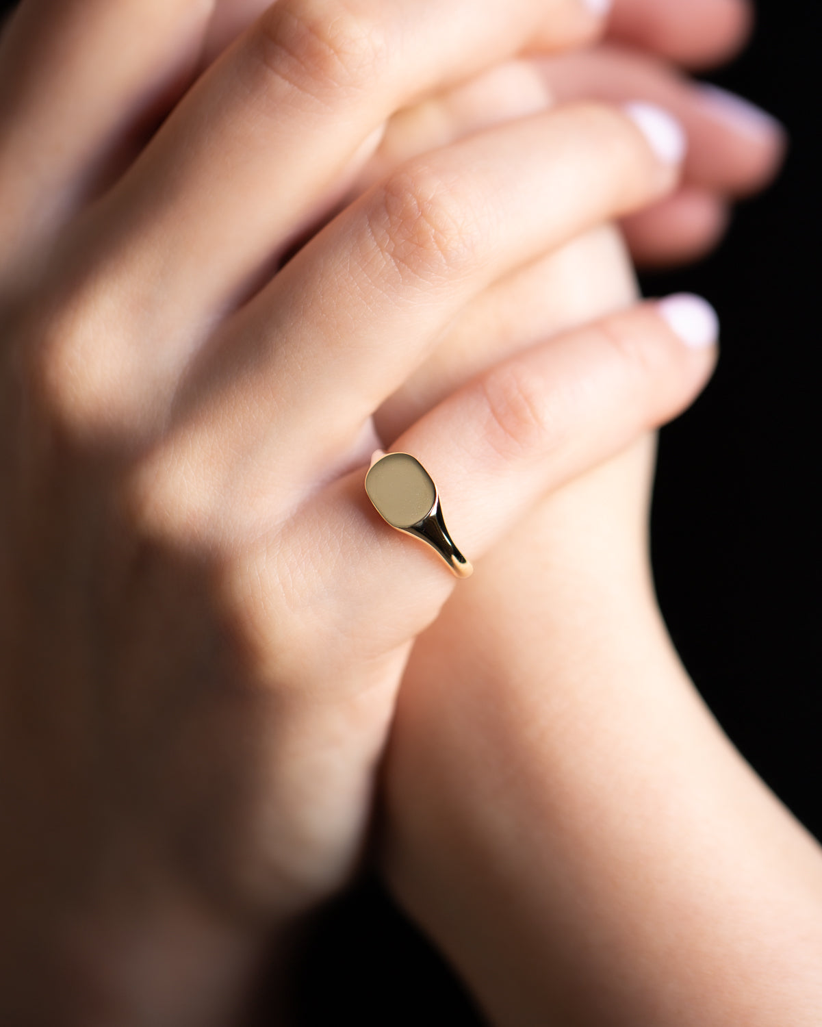 Little Squircle Signet Ring in yellow gold, a small gold signet ring worn on a finger
